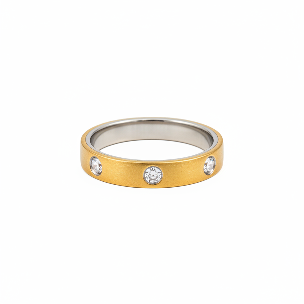 A two-tone ring band featuring a textured yellow gold outer surface with three bezel-set clear round stones, and a polished silver-toned inner band, shown on a plain white background.