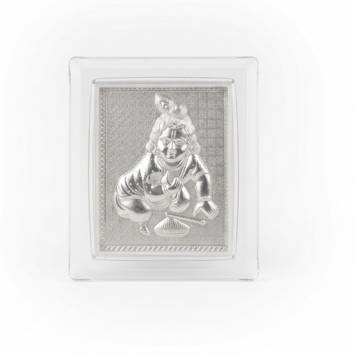 Silver idol in a crystal frame on a festive background with lights and flowers.