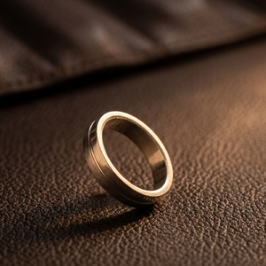 Gold ring on a brown leather surface