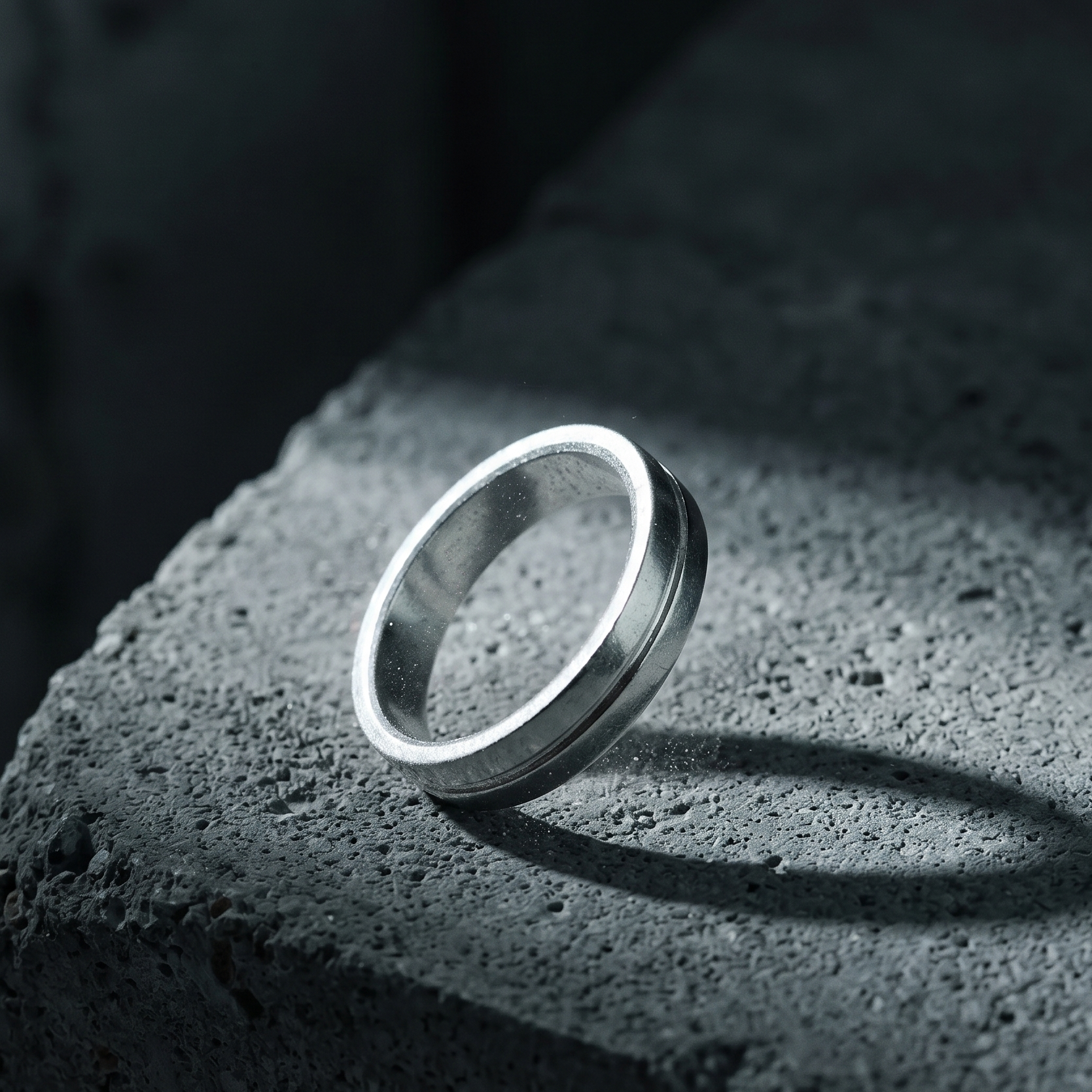 Silver ring on a textured dark surface