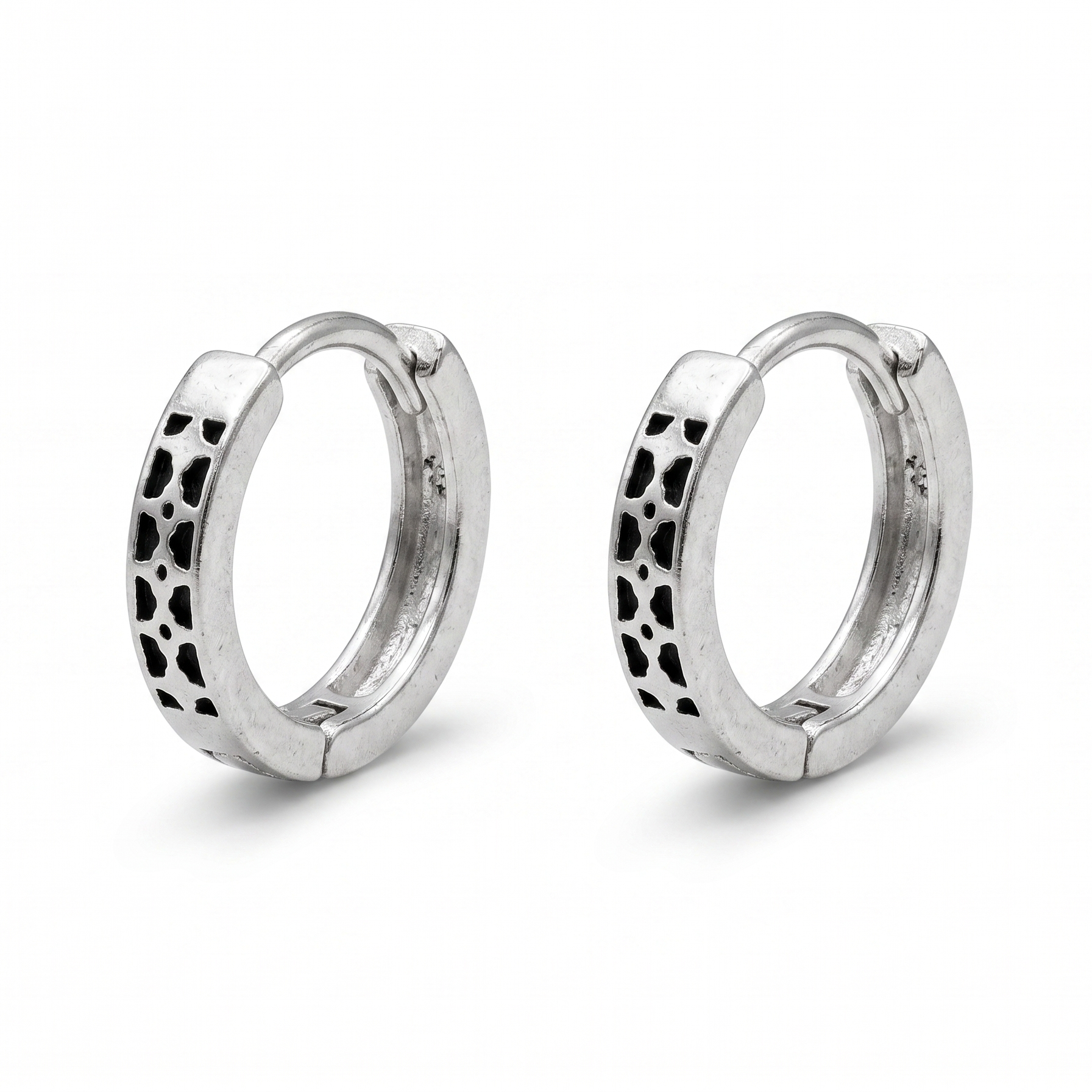 Pair of silver hoop earrings with black pattern on a white background