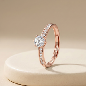 Rose gold diamond ring on a beige background
