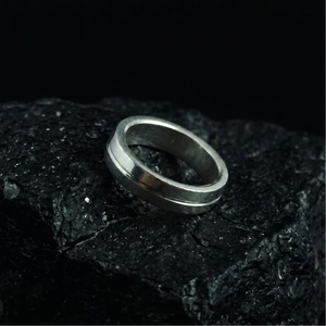 Silver ring on a dark textured surface