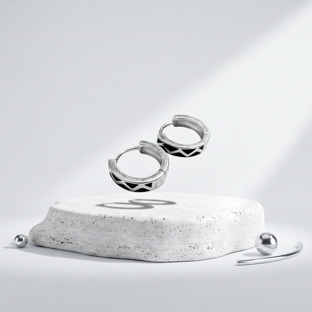 Silver hoop earrings on a white pedestal with 'Elegance in Design' branding.