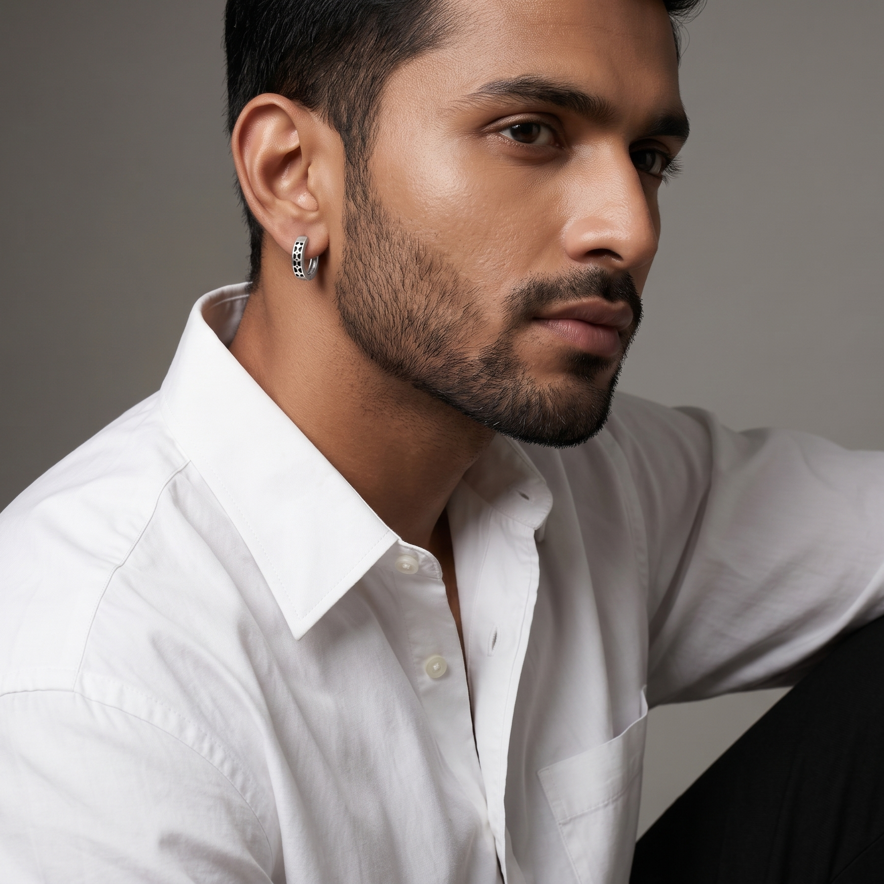 Man wearing a white shirt with a gray background