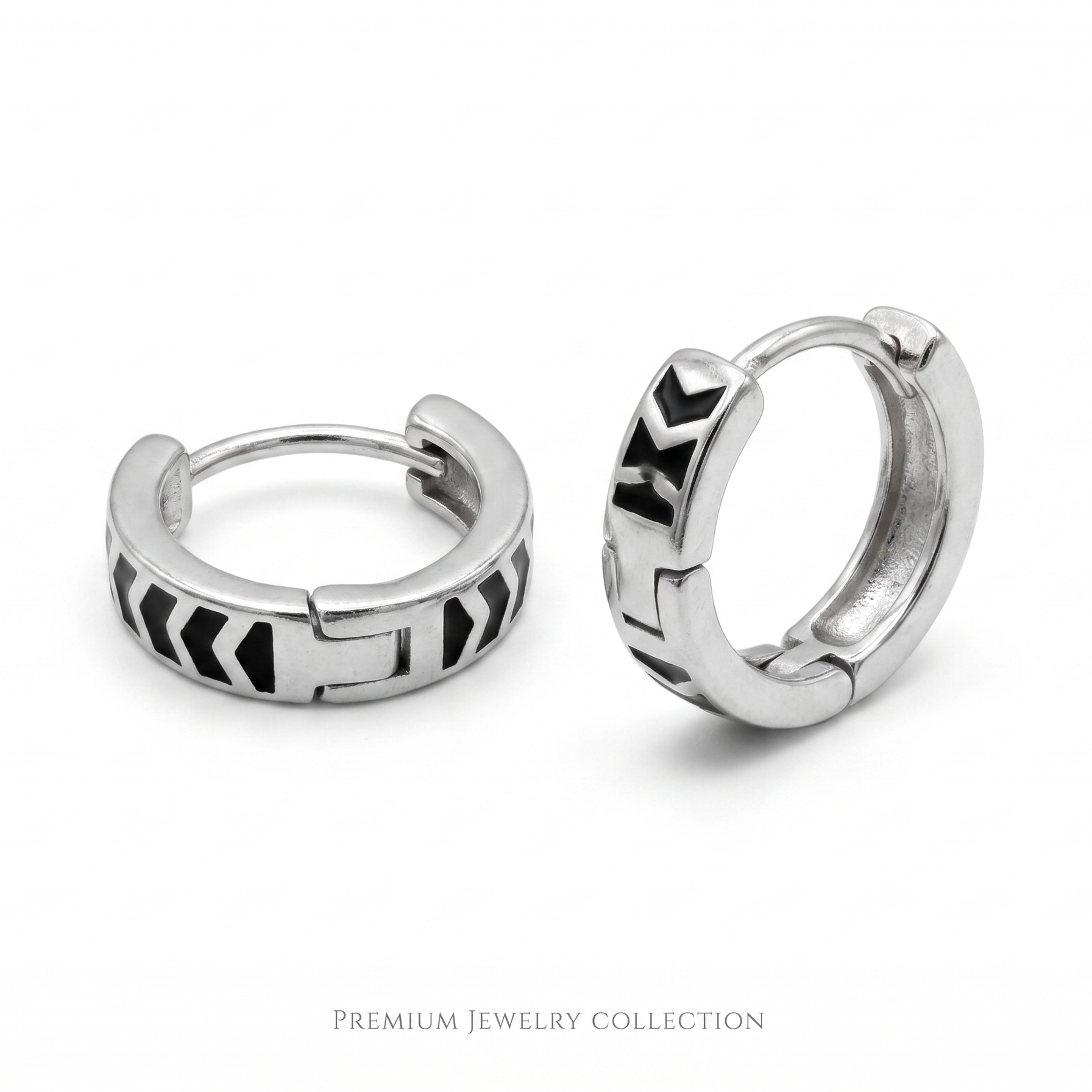 Pair of silver hoop earrings with geometric designs on a white background
