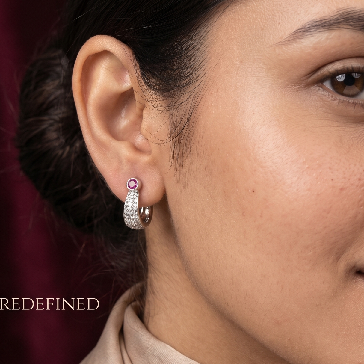 Close-up of a woman wearing earrings with a dark background
