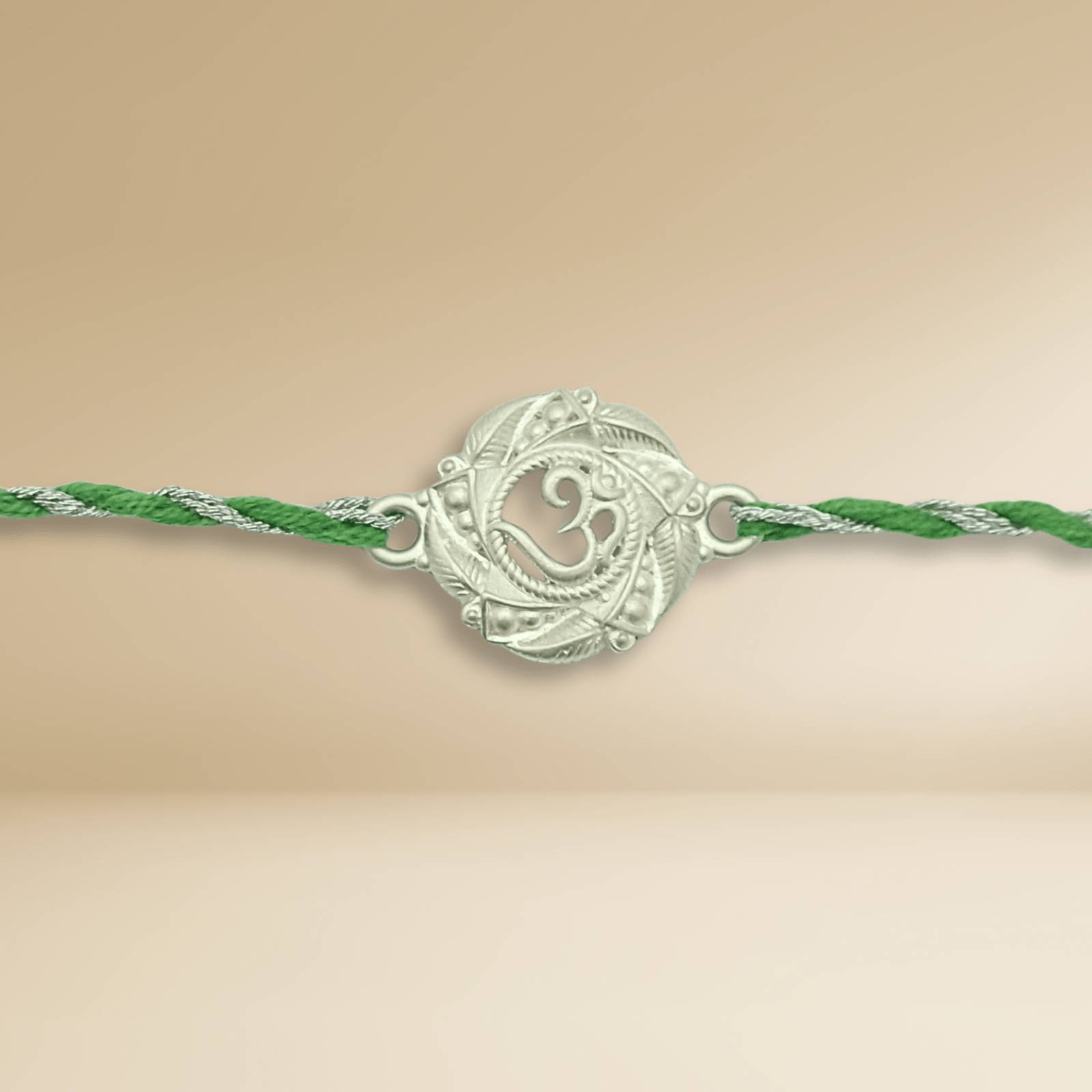 Antique Om Rakhi – Round Silver Medallion on Green Thread