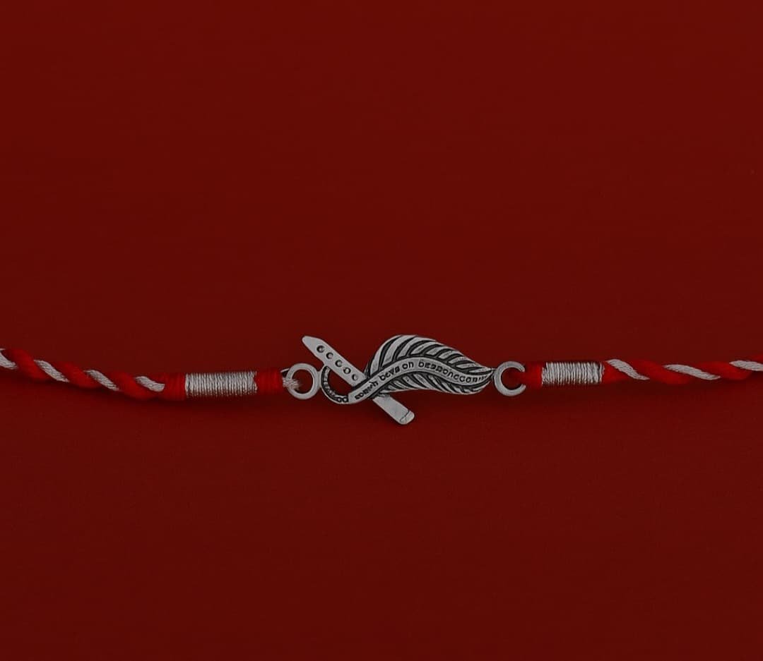 Infinity Feather Rakhi – Red Thread & Toggle Lock | Lustra Raksha Bandhan